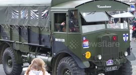 French children cheer D-Day parade in Port en Bessin, Normandy, France
