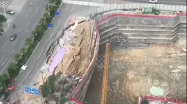 Destroyed road collapses onto a construction site in southern China