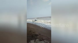 Car Driver run out as waves hit his car which got stuck in Beach in India.