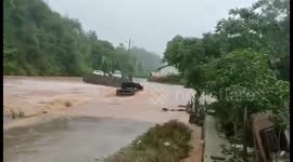 Flash floods sweep away car after driver tried to force their way through submerged road in China