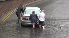 Kind men help stranded motorist during flooding in West London