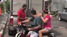 Pomeranian gets piggy back on motorcycle