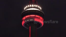Toronto CN tower glowing red in support of the Toronto raptors in their historia NBA finals playoff run