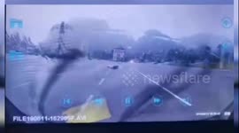 Lightning strikes ground inches away from scooter driver in China