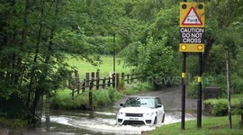 UK drivers cross flooded road in Birmingham despite warnings