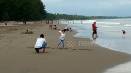a number of fathers in the fields play on the beach with their children