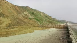 Dramatic footage shows moment cliff face collapses onto quiet UK beach