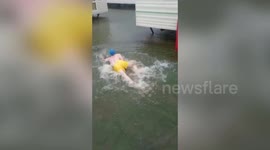 Hilarious video shows UK holidaymaker diving into floodwater from his caravan