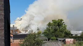 House on fire in Nazareth 'Steenweg Deinze' Belgium. Solar panels straw roofing