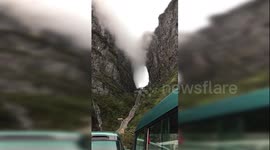 Mysterious scene shows clouds flowing through a mountain passage in China's Hunan