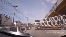 Concrete pipe falls off truck nearly crushing drivers on busy road in Thailand