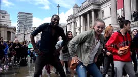 Scores of revellers dance the Macarena in London's Trafalgar Square
