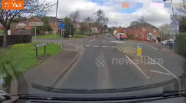 car pulls out in-front of van on a mini roundabout details pixelated
