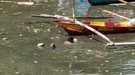Man filmed swimming through polluted river to look for 'useful garbage' in Indonesia