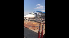 Son and father board small United Airlines jet