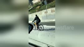 Passanger captures man riding bike on freeway