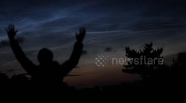 Electic Blue NLCs Over Late Night Traffic - Video