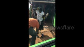 Ugandan woman dances with joy after receiving first ever pair of shoes from traveller