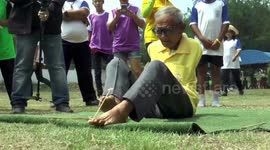 Thai pensioner born without arms has bizarre talent for firing crossbows with his FEET