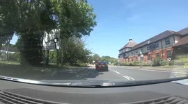Driver of BMW nearly causes accident on a roundabout