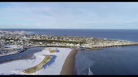 Lossiemouth beach covered in snow, scotland drone