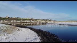 lossiemouth beach bridge covered in snow, scotland