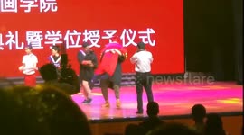 Excited graduate in China falls over on stage with university president in his arms