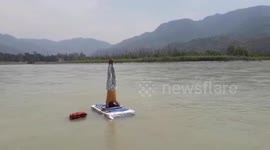 Agile man performs headstand in Ganges to mark International Yoga Day