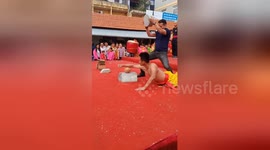 Vietnamese martial artist's arm resists concrete block being thrown onto it