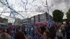 Whacky performers blast UK high street with streamers and confetti