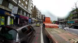 HGV truck cuts off bicycle cyclist and pushes him out of lane