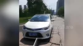 Chinese couple escape injury after broken water pipe impales car