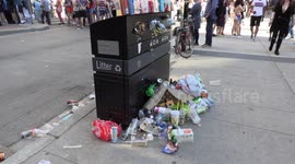 Piles of plastic waste litter and garbage at overflowing trash bins in Toronto.