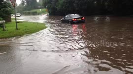 FILE: Motorists drive through flood waters in southern England