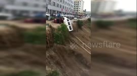 Flash floods in China's Yanhe sweep parked vehicles into Wu River after rainstorm