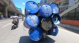 Crazy motorcycle overload! Man seen Carrying 8 metal Barrels On His Tiny Motorcycle
