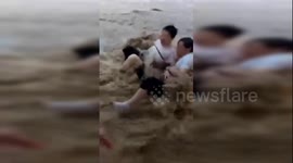 Pedestrians swept down road by flash flooding in China's Chongqing