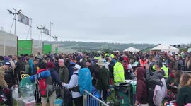 Thousands greeted with lengthy queues, mud and grey skies upon arriving at Glastonbury Festival