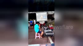 Man sets up outdoor karaoke stall under riverside bridge in China's Yichang