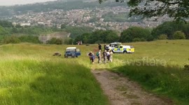 Police crime scene unit & drone operators searching over the cliff edge at High Tor, Giddy Edge, Matlock Bath, Matlock, Derbyshire, UK 27/06/2019