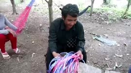 Cambodian father who couldn't afford to buy new rucksack for his son weaves one by hand from blue string