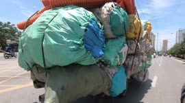 This vehicle in Viet Nam is ridiculously overloaded! Overloaded tricycles Carrying 17 large sacks