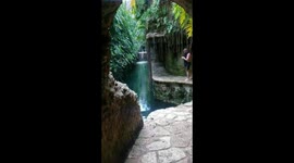 Tourist films incredible lush cenote in Mexico