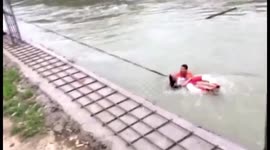 Firefighters rescue woman from being swept away by rapid water in southern China