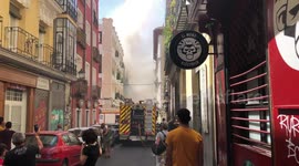 Firefighters on the scene as they attempt to extinguish flat fire in Madrid