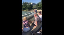People have foot spa in water fountain to cool down in Copenhagen