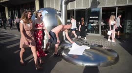 Two Men Heat Wet Clothes On Artwork