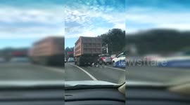 Woman riding a scooter narrowly survives being run over by a truck in China
