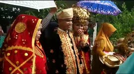 Traditional 'two bride' wedding march held in Indonesian town