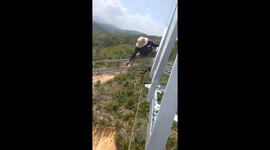 Worker climbs on high-voltage electric lines in Vietnam